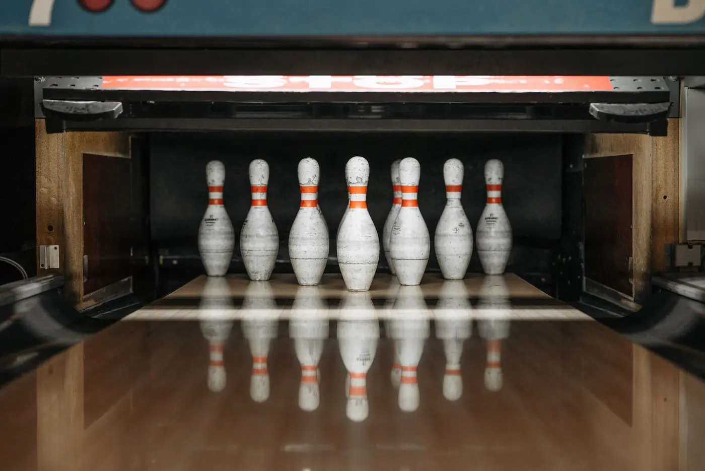Bowling pins set at the end of an empty lane
